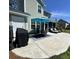 Spacious concrete patio with a grill, outdoor dining furniture, and lounge chairs overlooking the yard at 315 Grouse Park, Charleston, SC 29414