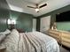 Green-walled bedroom featuring a bed, dresser, closet, ceiling fan, mirror, and TV at 315 Grouse Park, Charleston, SC 29414