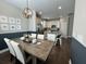 Inviting dining area with stylish chandelier, wood table, and easy access to the kitchen at 315 Grouse Park, Charleston, SC 29414