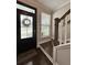 Welcoming entryway features a glass front door, staircase, and ample natural light at 315 Grouse Park, Charleston, SC 29414