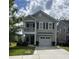 Charming two-story home with a front porch, balcony, manicured lawn, and a two-car garage at 315 Grouse Park, Charleston, SC 29414