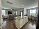 Open-concept living area featuring a kitchen island, dining space, and comfortable seating around a TV at 315 Grouse Park, Charleston, SC 29414
