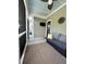 The screened in back porch features outdoor furniture and a mounted television for entertainment at 315 Grouse Park, Charleston, SC 29414