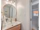 Bright bathroom with a round mirror, stylish vanity, and a modern design at 32 Briarcliff Dr, Charleston, SC 29407