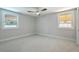 Empty bedroom with neutral carpet, baseboards, and two large windows offering natural light at 32 Briarcliff Dr, Charleston, SC 29407