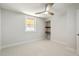 Cozy bedroom featuring neutral carpet, floating shelves, and a bright window at 32 Briarcliff Dr, Charleston, SC 29407