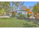 Charming single-story home with a well-manicured lawn, palm trees, and a unique architectural design at 32 Briarcliff Dr, Charleston, SC 29407