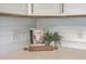 Kitchen countertop with a Magnolia Table cookbook, shiplap backsplash, and quartz countertops at 32 Briarcliff Dr, Charleston, SC 29407
