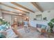 Spacious living room with white brick fireplace, exposed beams, and hardwood floors at 32 Briarcliff Dr, Charleston, SC 29407