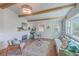 Sunlit living room with wooden beams, a cozy seating area, and a decorative fireplace at 32 Briarcliff Dr, Charleston, SC 29407