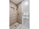 Elegant walk-in shower with wood look tiles and gold fixtures at 32 Briarcliff Dr, Charleston, SC 29407