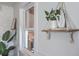 Close-up of shelving decor with a window, a white vase with greenery, and a stone hand at 32 Briarcliff Dr, Charleston, SC 29407