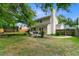 Exterior view of the home's backyard, featuring lawn, a trampoline, and tasteful landscaping at 332 Damascus Dr, Summerville, SC 29483