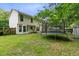 Spacious backyard featuring a large trampoline, ample grass, and partial view of the home's exterior at 332 Damascus Dr, Summerville, SC 29483