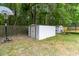View of the backyard with storage sheds, basketball hoop, trampoline, and fencing at 332 Damascus Dr, Summerville, SC 29483
