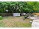 Inviting backyard featuring mature trees, lawn, sheds, privacy fence and basketball hoop at 332 Damascus Dr, Summerville, SC 29483