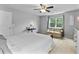 A bedroom with gray walls and carpet, featuring a sitting area, large windows and a ceiling fan at 332 Damascus Dr, Summerville, SC 29483