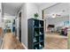 Hallway with wood-look flooring, a plant on a shoe rack, and view into a living area at 332 Damascus Dr, Summerville, SC 29483