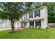 Well-maintained two-story home featuring a manicured lawn, blue shutters, and a two-car garage at 332 Damascus Dr, Summerville, SC 29483