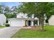 Charming two-story home featuring a two-car garage, manicured lawn, and shade tree at 332 Damascus Dr, Summerville, SC 29483