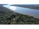 Beautiful aerial view of a waterfront property with mature trees and private pier at 3360 Baldwin Ln, Green Pond, SC 29446