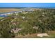 An aerial view shows the neighborhood near a home surrounded by lush green trees at 339 Sea Cloud Cir, Edisto Island, SC 29438