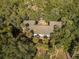 An aerial view displays a charming home nestled among a dense forest of lush green trees at 339 Sea Cloud Cir, Edisto Island, SC 29438