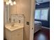 Bathroom with vanity, sink, mirror with mosaic tiles and partial view of bedroom through doorway at 339 Sea Cloud Cir, Edisto Island, SC 29438