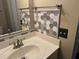 Close-up view of bathroom with white vanity, sink, mirror with decorative gray hexagon tile at 339 Sea Cloud Cir, Edisto Island, SC 29438