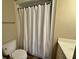 Bathroom shower-tub combination with tiled walls behind a white curtain at 339 Sea Cloud Cir, Edisto Island, SC 29438
