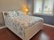 Well-lit bedroom showcasing a white frame bed, neutral walls and matching seashell patterned comforter at 339 Sea Cloud Cir, Edisto Island, SC 29438
