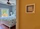 View of a bedroom with a balcony through a doorway, hardwood flooring and ceiling fan at 339 Sea Cloud Cir, Edisto Island, SC 29438