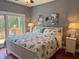 Bedroom featuring a balcony, two side tables and hardwood flooring at 339 Sea Cloud Cir, Edisto Island, SC 29438