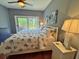 Comfortable bedroom features a ceiling fan, nightstand, and sliding glass door to the deck at 339 Sea Cloud Cir, Edisto Island, SC 29438