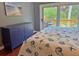 Comfortable bedroom features a blue dresser and sliding glass door to the deck at 339 Sea Cloud Cir, Edisto Island, SC 29438