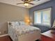 Comfortable bedroom with a ceiling fan and a bright window with a wooded view at 339 Sea Cloud Cir, Edisto Island, SC 29438