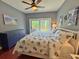 Comfortable bedroom features a ceiling fan and sliding glass door to the deck at 339 Sea Cloud Cir, Edisto Island, SC 29438