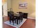 Dining area features a dark wood table with seating for six and a decorative rug at 339 Sea Cloud Cir, Edisto Island, SC 29438
