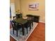Dining room with black dining set, decorative rug, and coastal artwork at 339 Sea Cloud Cir, Edisto Island, SC 29438