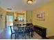 Open dining area features a decorative carpet, table, and a view to the kitchen and outside patio at 339 Sea Cloud Cir, Edisto Island, SC 29438