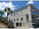 View of building, set back from street, with palm trees and stairs leading to the entrance at 339 Sea Cloud Cir, Edisto Island, SC 29438