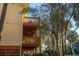 Three stories of wood balconies against a butter-yellow clapboard building, shaded by trees at 339 Sea Cloud Cir, Edisto Island, SC 29438