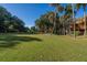 Lush green lawn with trees and a view of the surrounding community at 339 Sea Cloud Cir, Edisto Island, SC 29438