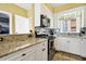Bright kitchen with granite counters, stainless appliances, mosaic backsplash and ample cabinet space at 339 Sea Cloud Cir, Edisto Island, SC 29438