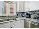Modern kitchen featuring granite countertops, stainless steel appliances, and stylish backsplash at 339 Sea Cloud Cir, Edisto Island, SC 29438