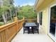 View of patio with four black chairs and a table and trees in the background at 339 Sea Cloud Cir, Edisto Island, SC 29438