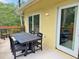 View of patio with four black chairs and a table with trees in the background at 339 Sea Cloud Cir, Edisto Island, SC 29438