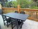 View of patio with four black chairs and a table with trees in the background at 339 Sea Cloud Cir, Edisto Island, SC 29438