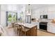 Bright kitchen featuring white cabinets, pendant lighting, an island with barstool seating, and a stainless steel refrigerator at 353 Claret Cup Way, Charleston, SC 29414