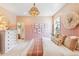 Charming bedroom with a pink accent wall, a decorative chandelier, and tasteful decor at 357 Claret Cup Way, Charleston, SC 29414